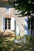 Country garden with surfboard leaning up against house