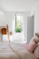 White country bedroom with open window in summer 