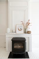Black wood burning stove and white painted chimney breast 