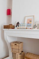 Mantelpiece with pictures and toys in childrens room 