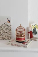 Toy bird cage and book in childrens room 