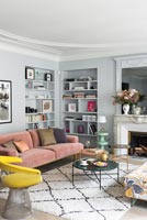 Grey painted walls and alcove shelving in modern living room 