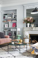 Pale grey painted walls and alcove shelving in modern living room 