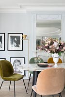Vintage furniture and framed black and white photographs in dining room 