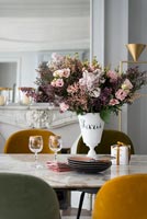 Vase of flowers on vintage dining table 
