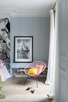 Modern pink chair in bedroom with parquet floor