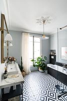 Bathroom with patterned black and white flooring 