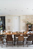 Modern country dining room with exposed stone feature wall at Christmas time