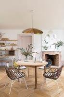 Modern chairs around circular wooden table 