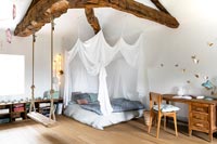 Swing in bedroom with canopy and desk 
