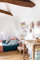 Childrens bedroom with vaulted ceiling and canopy over bed 