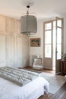 Country bedroom with large unusual pendant light