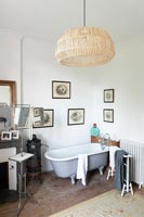 Large lampshade on pendant light in country bathroom 
