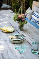 Plates and glasses on outdoor dining table 
