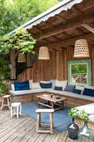 Outdoor living area in wooden shelter 