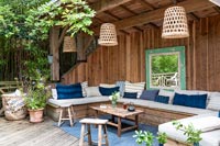 Outdoor living room area in wooden shelter 