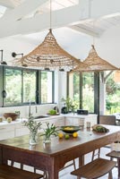 Large wooden dining table in white kitchen-diner 