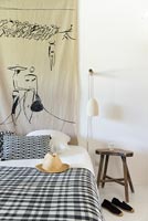 Painted wall hanging in black and white modern country bedroom 