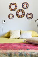 Display of patterned rings on bedroom wall 