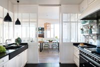 Modern country black and white kitchen with view to dining area 