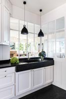 Modern black and white kitchen sink unit with pendant lights 