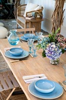 Blue crockery on outdoor dining table 