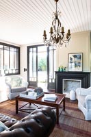 Classic living room with open French windows in summer 