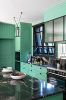Mint green kitchen with marble worktop 