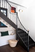 Modern country hallway - monochrome painted staircase and built in seating 