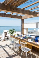 Dining area on decking with sea views 