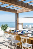 Dining table on decking overlooking the sea