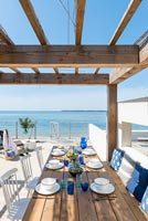 Dining area on decking overlooking the sea 