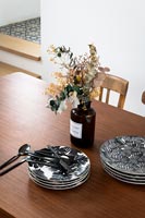 Black and white plates on modern dining table 