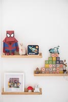 Toys displayed on wooden shelves 