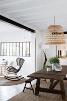 Modern country dining room with wicker rocking chair 