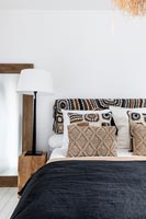 Patterned fabric on headboard in modern country bedroom 