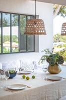Wicker lampshade over outdoor dining table, summer 
