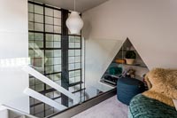 Mezzanine room with glass wall and triangular alcove shelves 