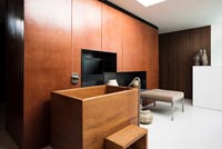 Wooden bath with wall mounted television 