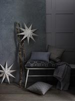Grey soft furnishings in modern living room with white star decorations 