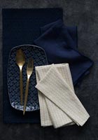 Dark blue and gold napkins and crockery 