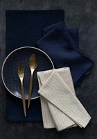 Dark blue and gold napkins and crockery 