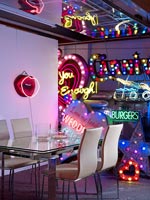 Dining room filled with neon signs 