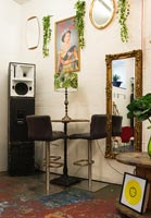 Large stack of speakers in corner of eclectic living room