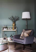 Modern living room with dark grey painted walls and drinks trolley