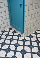 Dark blue and white patterned tiled flooring in bathroom 