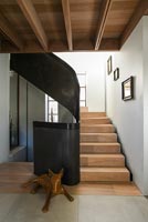 Sculpture of dog on landing of modern staircase 