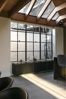 Sideboard in large window of modern industrial kitchen-diner 
