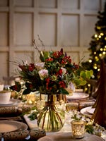 Flower arrangement on dining table decorated for Christmas 