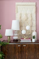 Collection of white lamps on sideboard 